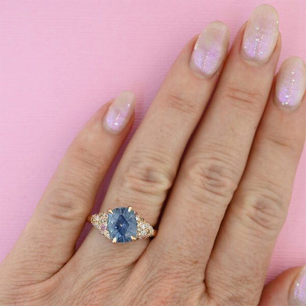 cushion-cut-cornflower-blue-montana-sapphire-oppulant-ring-sketch-on-hand-pink