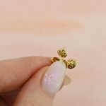 pear-shaped-diamond-stud-earring-petals-held-between-fingers (1)